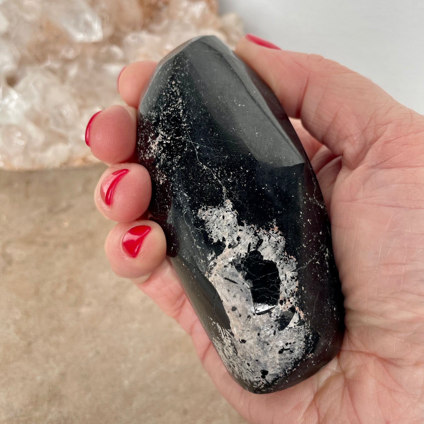 Black Tourmaline Free Form in the palm of the hand.