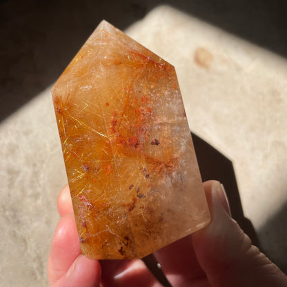 Golden rutile Quartz tower with red and gold inclusions 