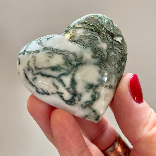 Hand holding Moss Agate Heart