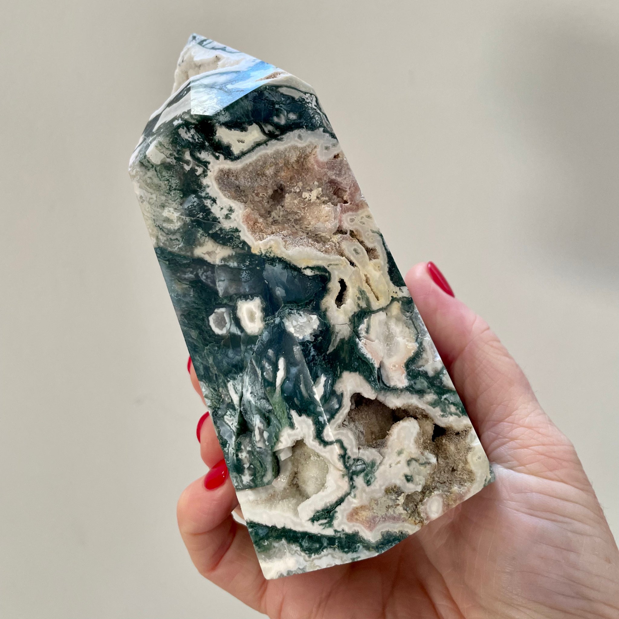 Hand holding Moss Agate Tower 14cm