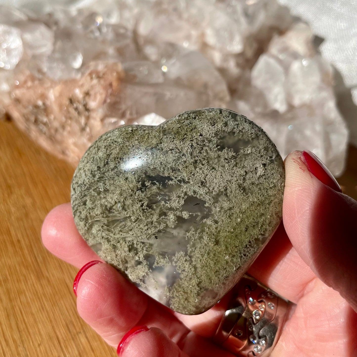 Hand holding Moss Agate Heart