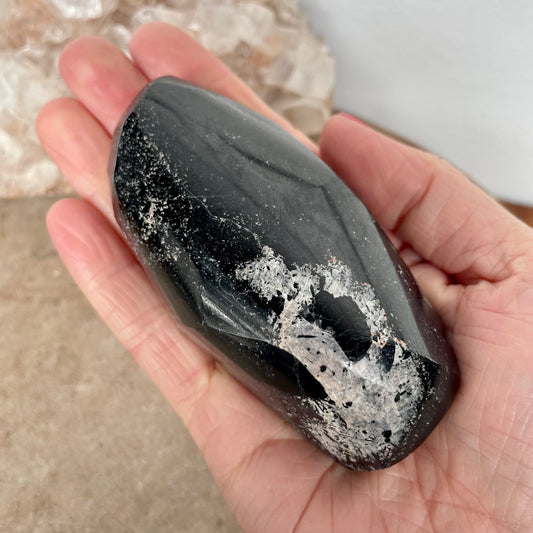 Black Tourmaline Free Form in the palm of a hand.