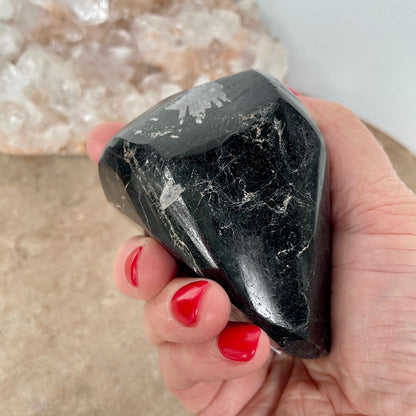 Black Tourmaline Free Form in the palm of a hand.