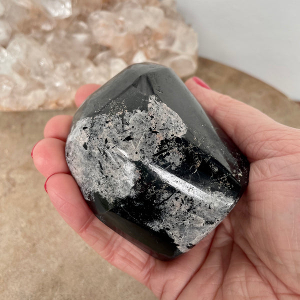 Black Tourmaline Free Form  in the palm of a hand.