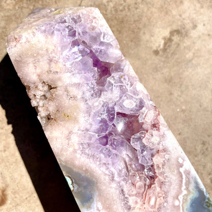 Pink and Purple Amethyst Tower with Druzy on bench