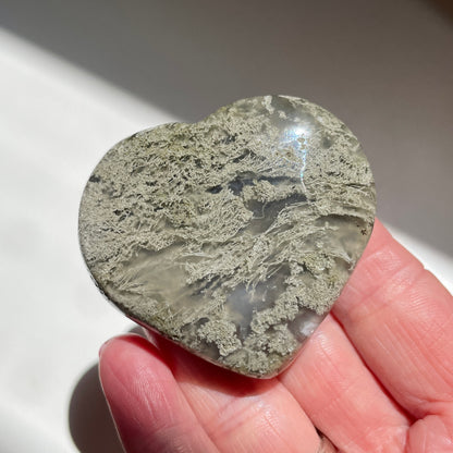 Hand holding Moss Agate Heart