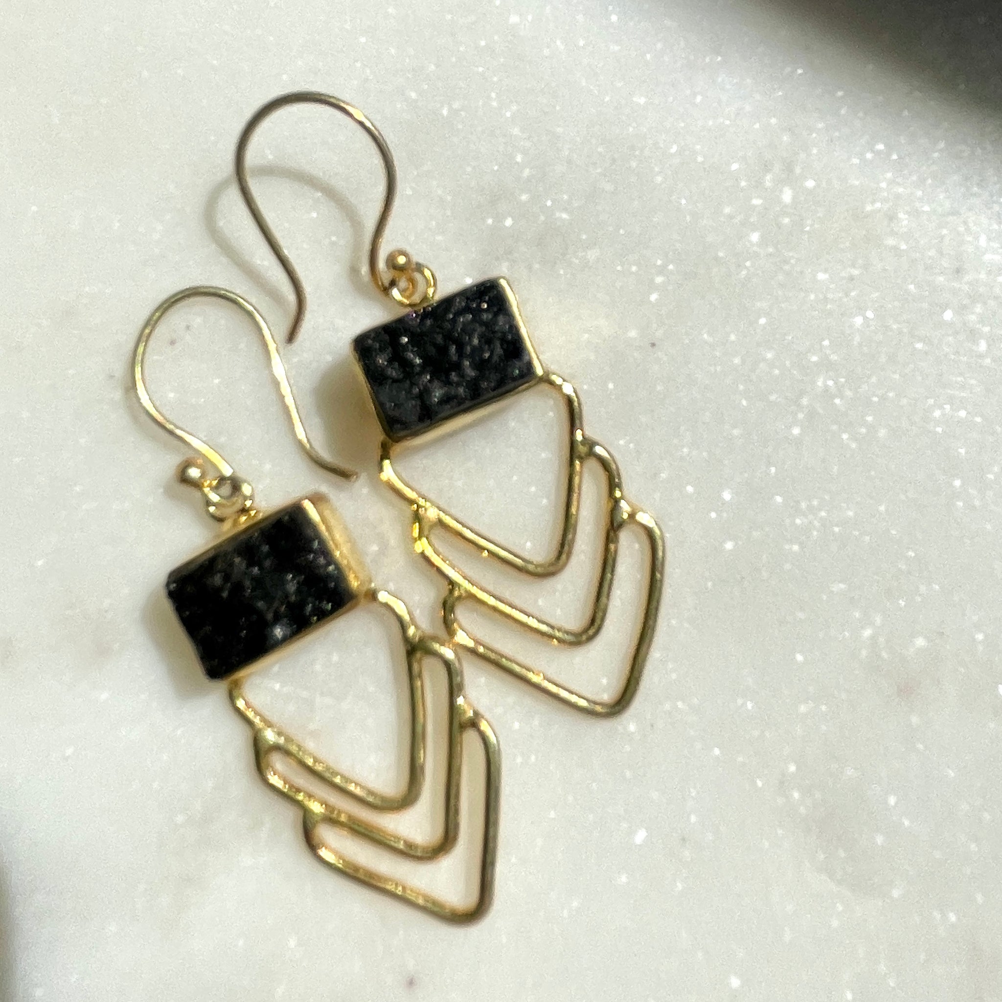 Black Tourmaline Earring on crystal background.